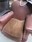 Brown faux leather armchair.