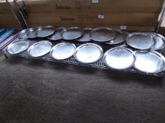 20 round stainless steel trays. Estimate £20-25.