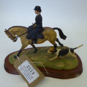 Border Fine Arts model of a lady riding side saddle on a Dun horse with a hound by her side, on a