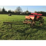 FOUR-WHEEL PLEASURE VEHICLE finished in natural varnished wood edged in carved detailing, and red
