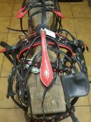 Set of red/black pony driving harness with horseshoe buckles