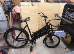 BAKER'S PUSH BIKE painted black with metal front cage for a breadbasket and sign written 'Co-