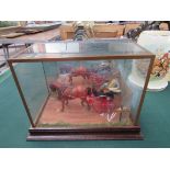 Model of a horse and cart displayed in a case