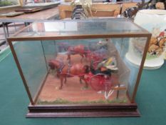 Model of a horse and cart displayed in a case