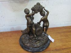 Large bronze figural set of 3 Bacchanalian nude boys on marble base. Estimate £60-90.