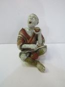 Japanese figurine of a beggar, as found, height 14cms. Estimate £100-150.