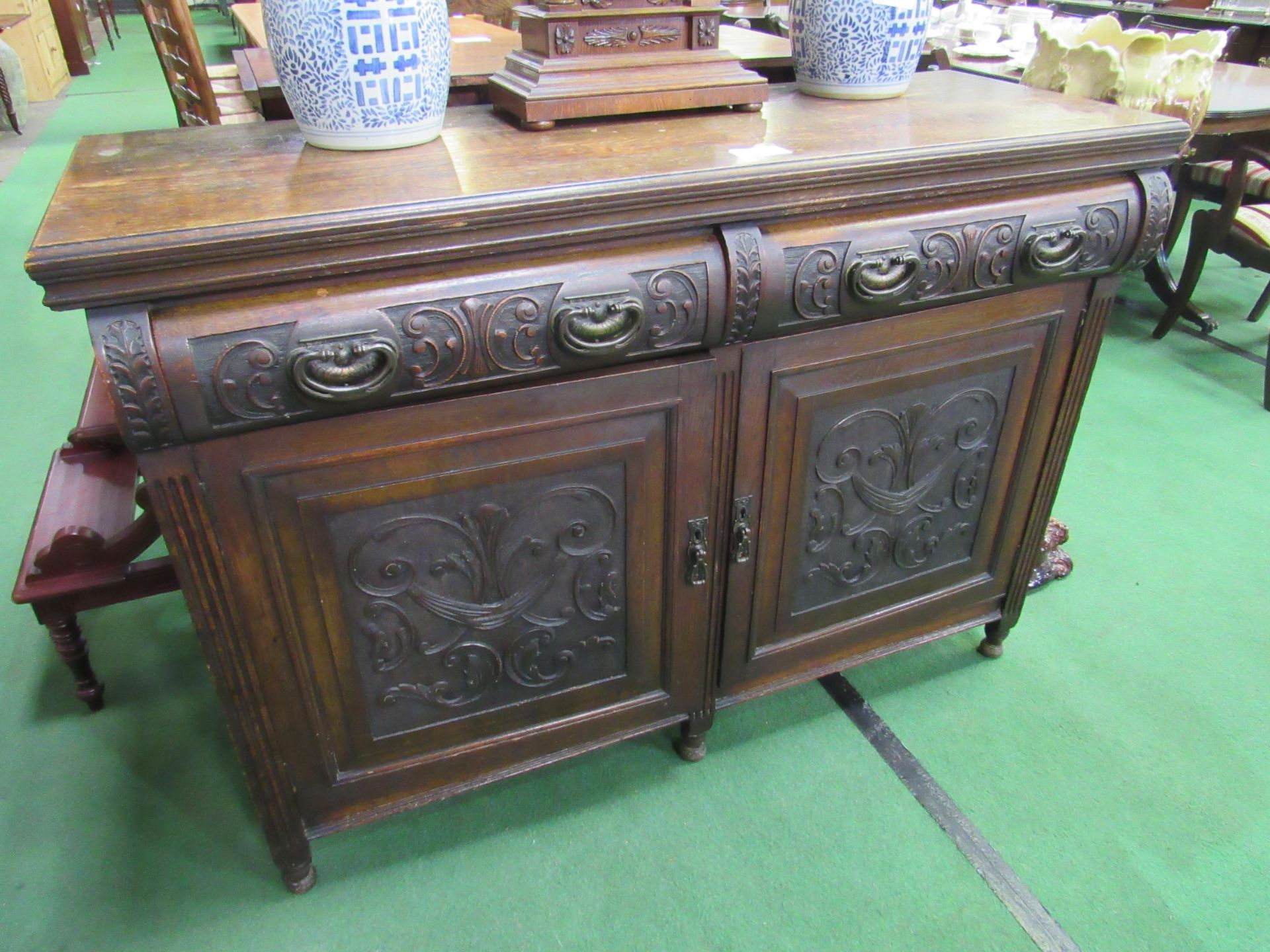 Oak sideboard with carved drawers and cupboard doors, 137 x 53 x 98cms. Estimate £10-20