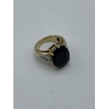 9ct gold ring with large centre sapphire and white sapphires to shoulders, weight 10.5gms, size N