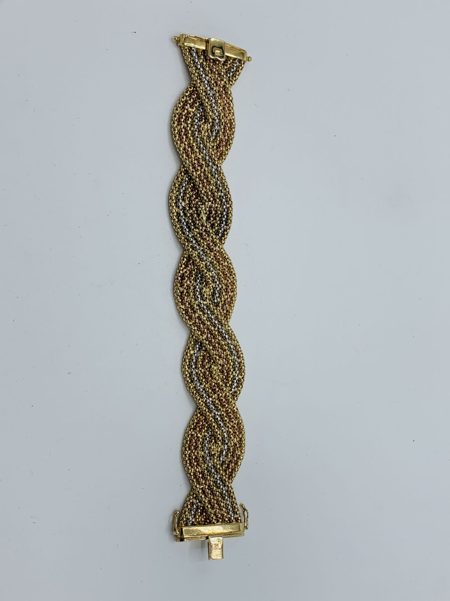 9ct yellow, white and rose gold plaited bracelet, length 19cms, weight 4.2gms. Estimate £750-800. - Image 2 of 2