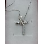 9ct white gold zircona set cross necklace. Estimate £30-40.