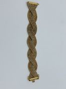 9ct yellow, white and rose gold plaited bracelet, length 19cms, weight 4.2gms. Estimate £750-800.