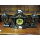 Slate clock set with two figurines garnitures. Height of clock: 32cms. Estimate £40-60.