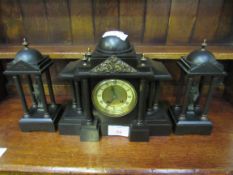 Slate clock set with two figurines garnitures. Height of clock: 32cms. Estimate £40-60.