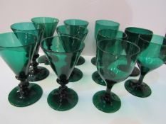 Set of 6 handmade dark green wine glasses together with 5 others (2 as found). Estimate £50-80.