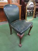 Green leather upholstered chair on ball and claw feet at front. Estimate £30-50.