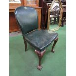 Green leather upholstered chair on ball and claw feet at front. Estimate £30-50.