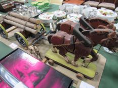 Antique wooden model of a logging waggon pulled by 2 horses, plus man and dog. Estimate £20-40.