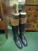 Pair of mahogany topped riding boots complete with wooden trees by Berkeley & Sons. Estimate £20-