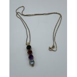 Yellow metal 4 gemstone pendant on a 9ct gold chain, chain length 48cms. Estimate £250-280.