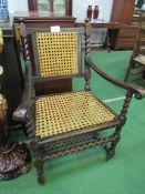 Oak armchair with cane back and seat. Estimate £20-30.