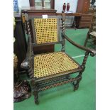 Oak armchair with cane back and seat. Estimate £20-30.