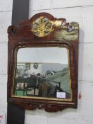 A Georgian mahogany Sheraton wall mirror. Mahogany veneer with parcel gilt waterfall relief