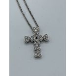 18ct white gold heart shaped clusters of diamonds in the form of a cross, on a white gold chain,