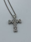 18ct white gold heart shaped clusters of diamonds in the form of a cross, on a white gold chain,