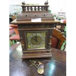 Oak cased mantel clock by W&H Son. Estimate £40-60.
