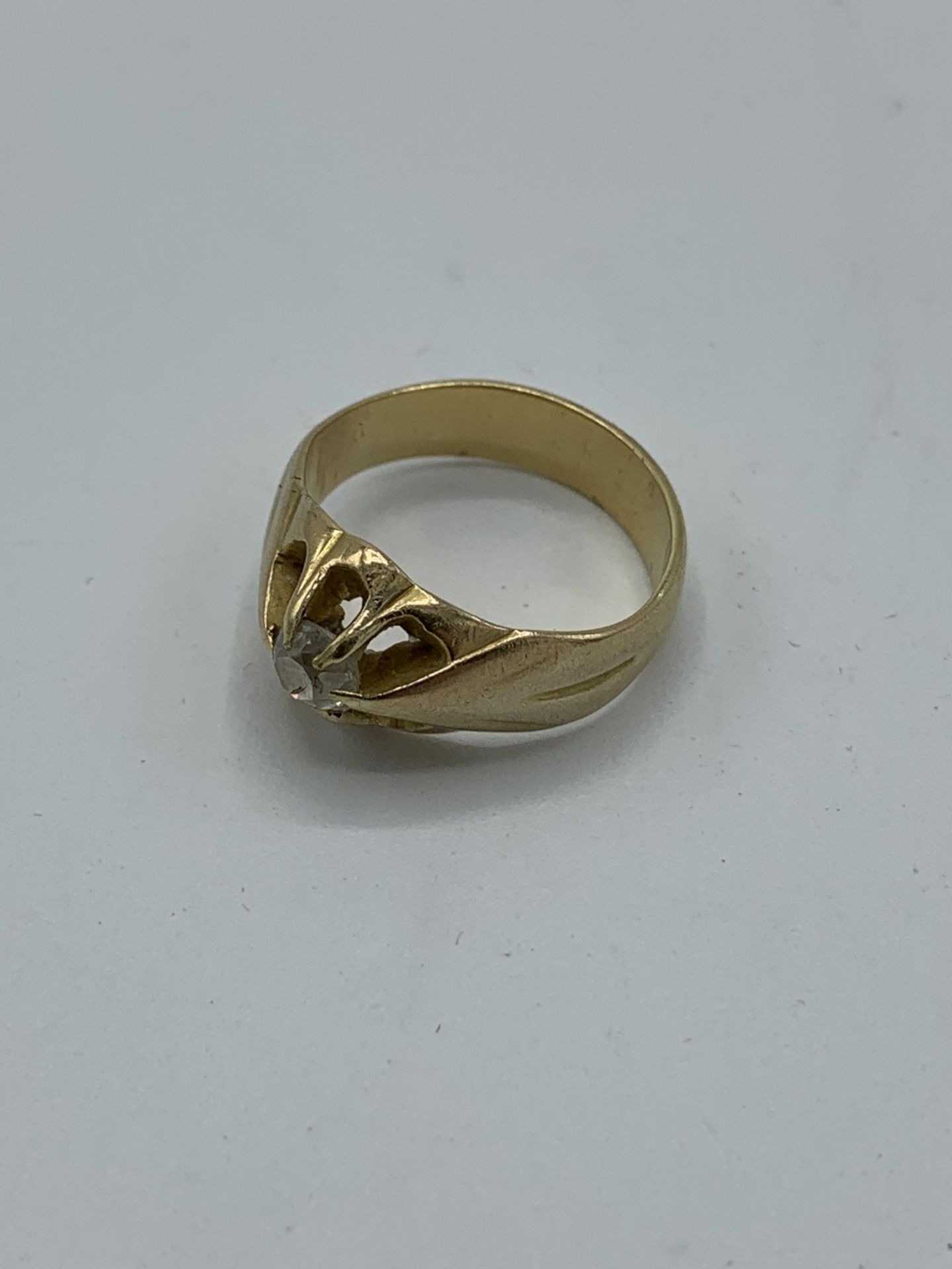 Yellow metal and diamond ring, size J, weight 5.2gms. Estimate £150-180.