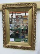 Gilt ornately framed wall mirror, 67 x 50cms. Estimate £10-20.