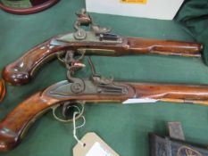 Pair of reproduction flint lock pistols. Estimate £30-40.