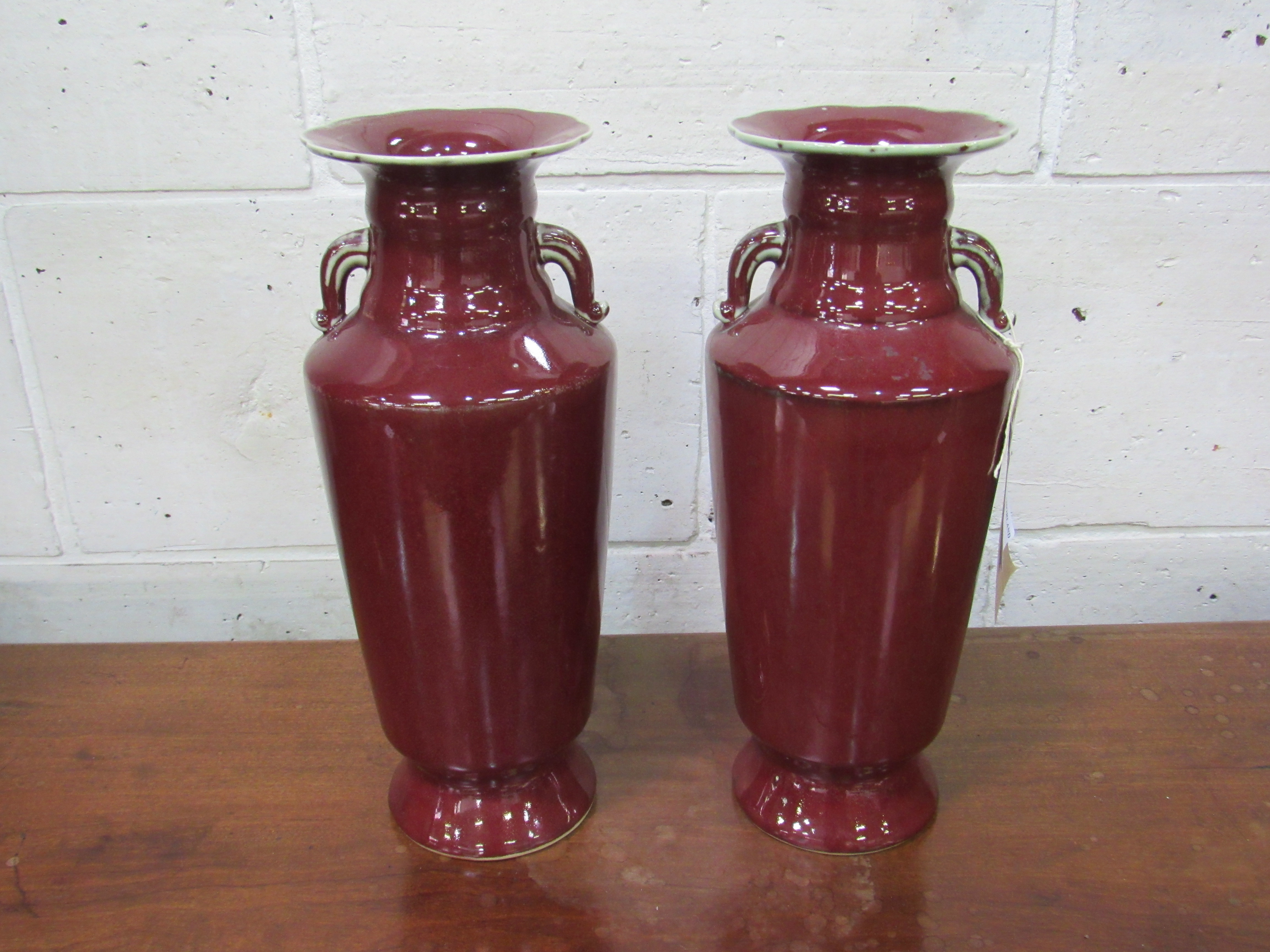 A pair of Sang de Boeuf vases. Height 35cms. Estimate £50-80.