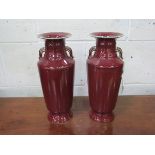A pair of Sang de Boeuf vases. Height 35cms. Estimate £50-80.