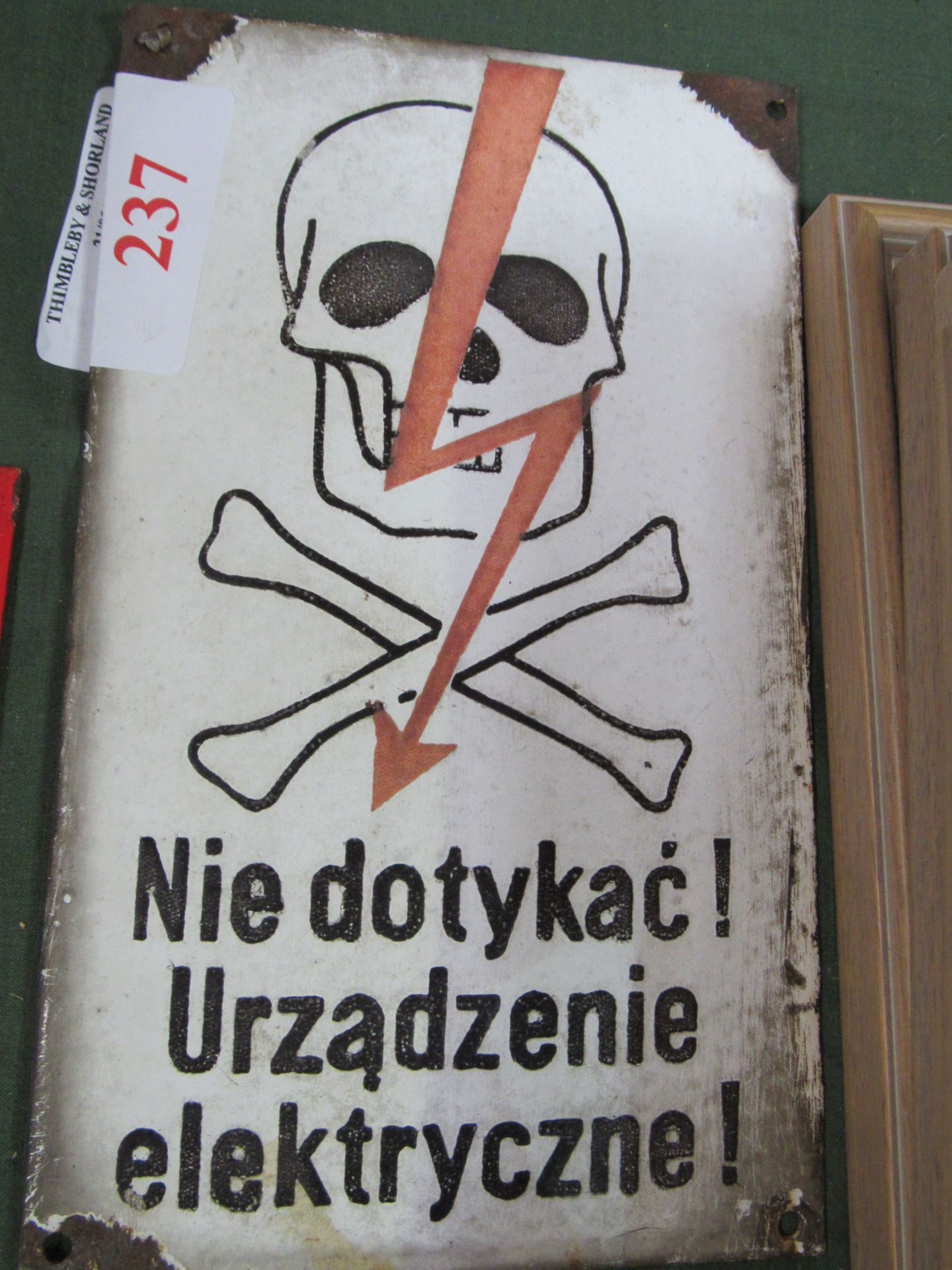 Domed enamel sign, ""Death by electrocution hazard"", with skull & crossbones. Estimate £30-50.
