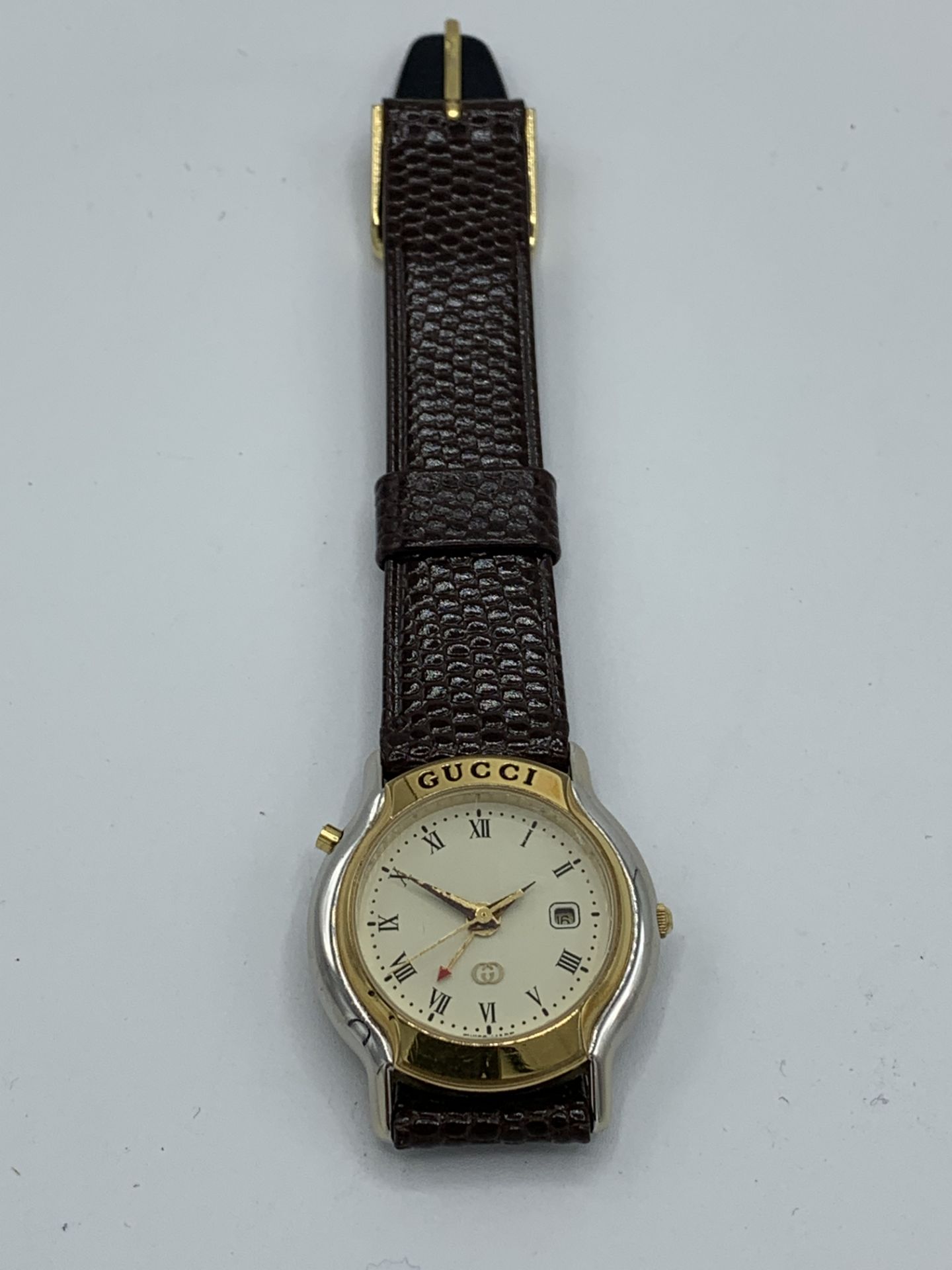 Lady's Gucci Mondiale gold tone stainless steel quartz wrist watch on a brown leather strap, Ref No: