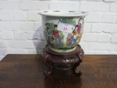 Large round Chinese Famille Verte fish bowl or Jardinière on ornate wood stand. Estimate £30-50.