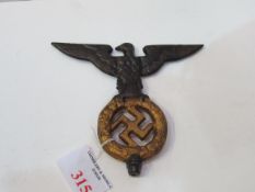 Cast metal Nazi staff top piece, a Spread-Eagle over Swastika. Estimate £40-60.