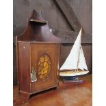 Reproduction model yacht, height 62cms. Mahogany wall cupboard with inlaid oval front. Estimate £