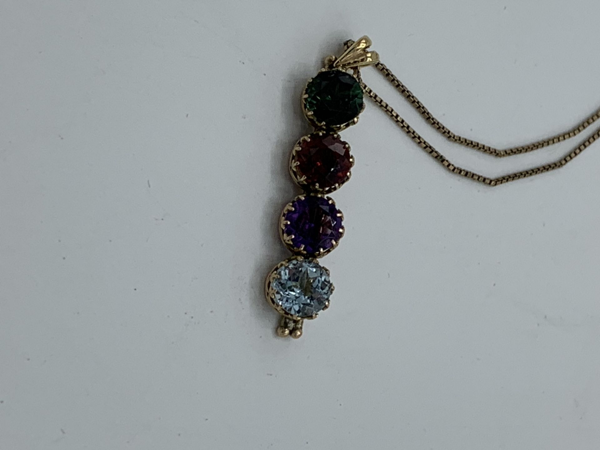 Yellow metal 4 gemstone pendant on a 9ct gold chain, chain length 48cms. Estimate £250-280. - Image 2 of 3