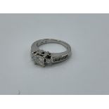 14ct white gold princess cut diamond 3 stone ring with diamonds to the shoulder, weight 4.6gms, size