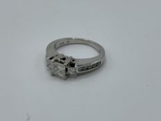 14ct white gold princess cut diamond 3 stone ring with diamonds to the shoulder, weight 4.6gms, size