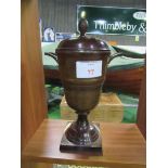 Brown lustre painted metal covered urn. Height 36cms. Estimate £20-30.