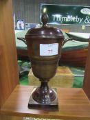 Brown lustre painted metal covered urn. Height 36cms. Estimate £20-30.