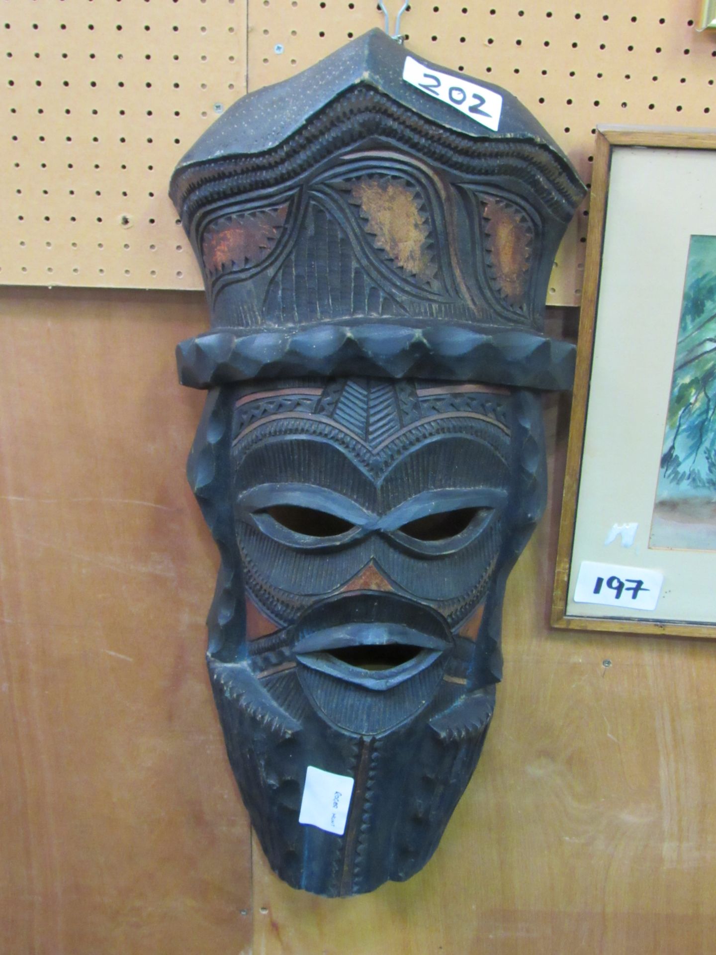 Balinese ceremonial mask depicting a war god, coloured with vegetable dye. Height 76cms. Estimate £