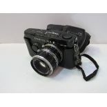 Olympus Pen-F camera body, lens and case. Estimate £80-100.