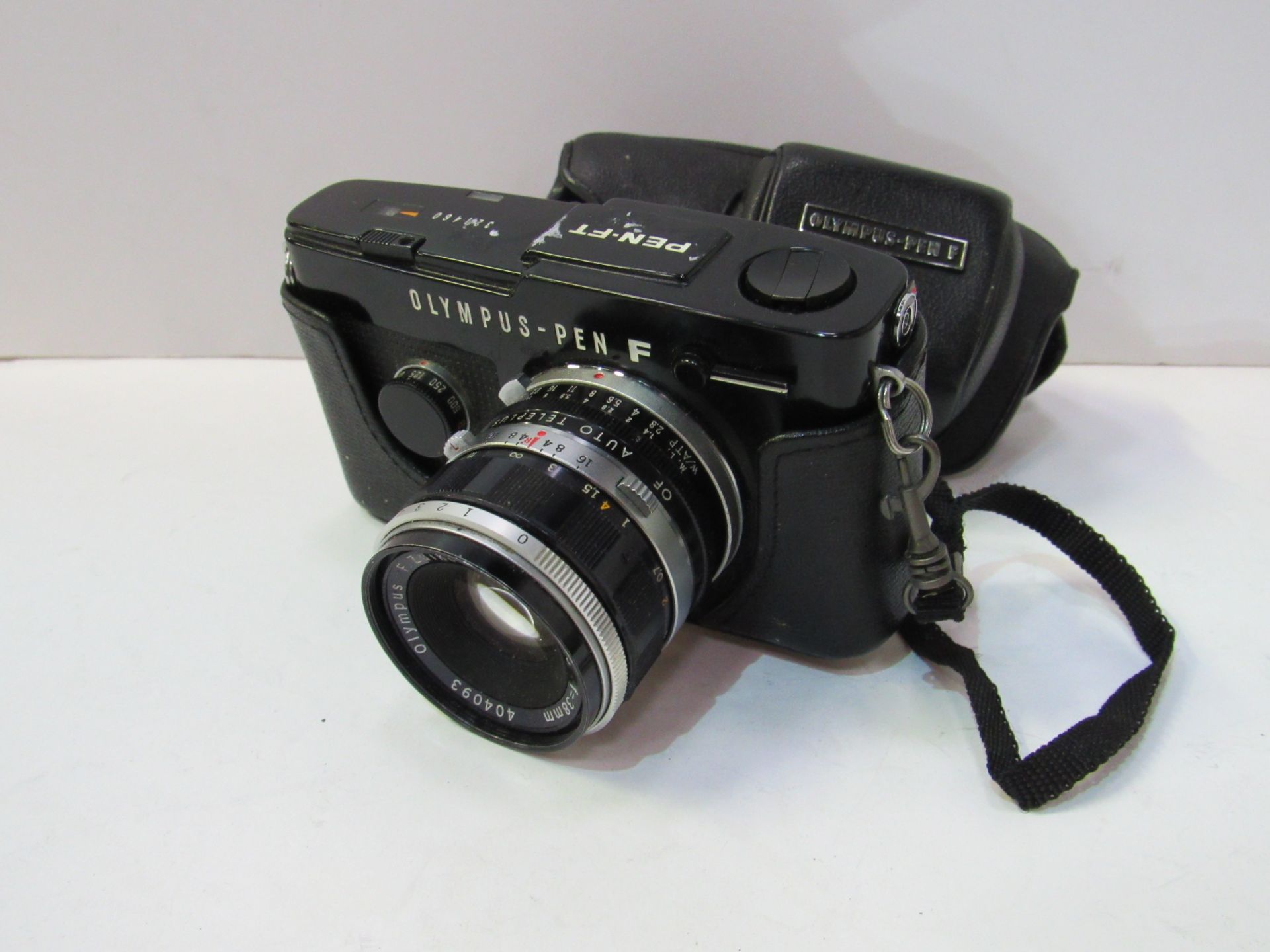 Olympus Pen-F camera body, lens and case. Estimate £80-100.