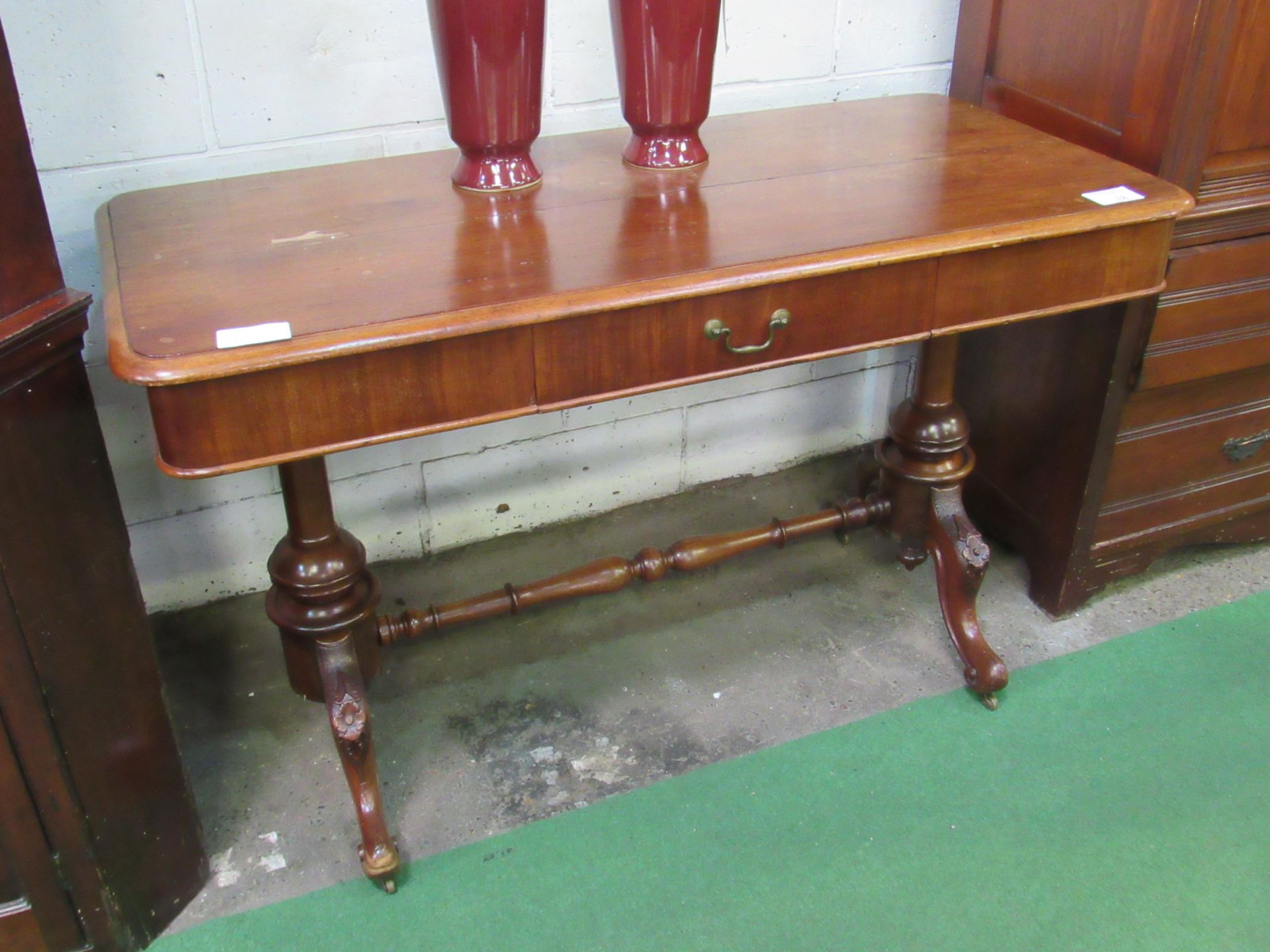 Mahogany library table with frieze drawer on turned stretcher to twin pedestals. 122 x 57 x 75cms.