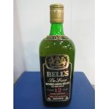 26 2/3fl.oz bottle of Bells De Luxe blended Scotch whisky 12 year old, 70 proof. Estimate £20-40.
