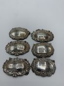 6 silver decanter labels, total weight 2.4ozt. Estimate £20-30.